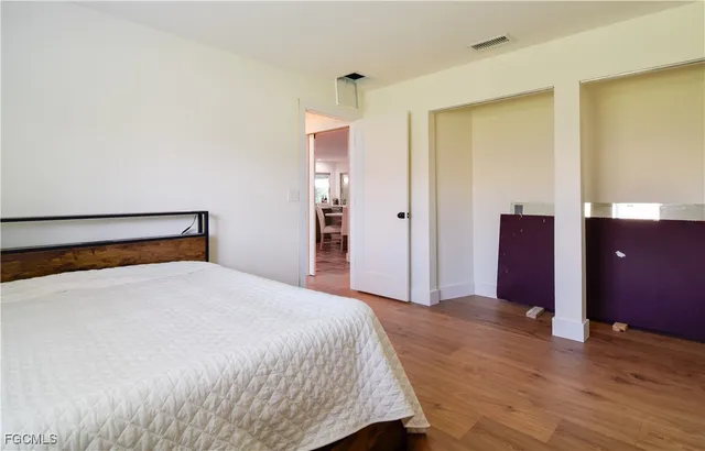 a view of a kitchen with kitchen island a sink and a refrigerator