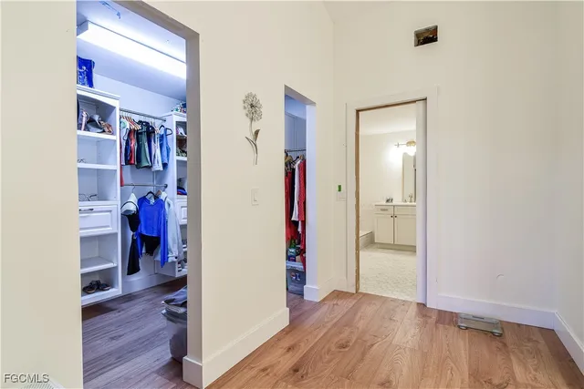 a view of walk in closet with clothes and shoes