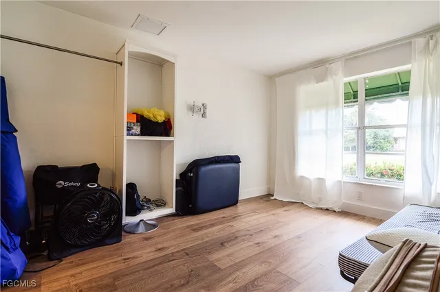a room with wooden floor and furniture