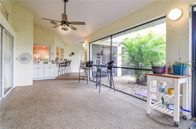 a view of a house with a yard and palm trees