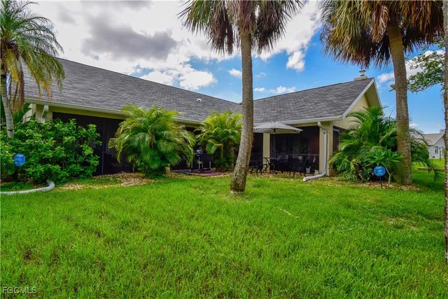 a view of a patio with table and chairs potted plants and palm tree