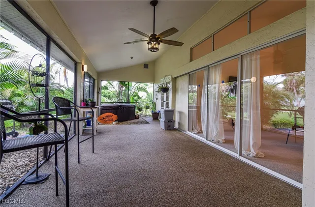 a dining room with furniture water view and a floor to ceiling window