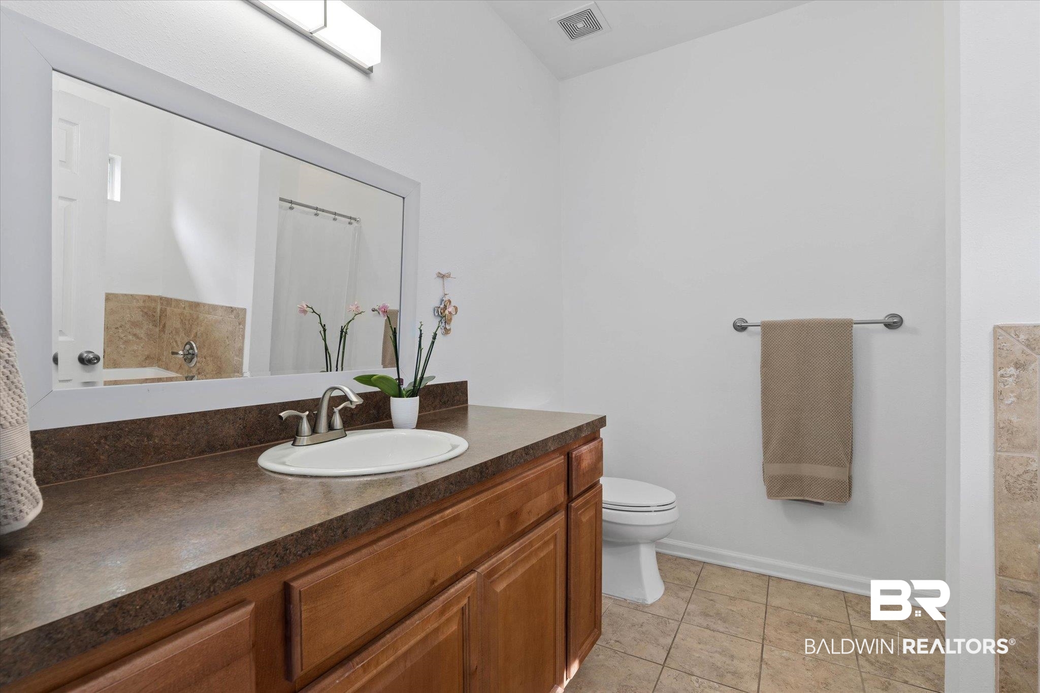1910 Hunter Avenue Mobile, AL 36606 - Photo 12 of 21 Full bathroom with vanity, toilet, baseboards, and tile patterned floors
