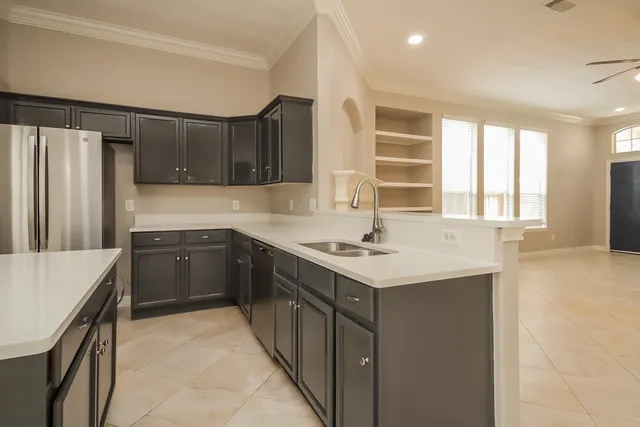 a kitchen with a sink stove and refrigerator