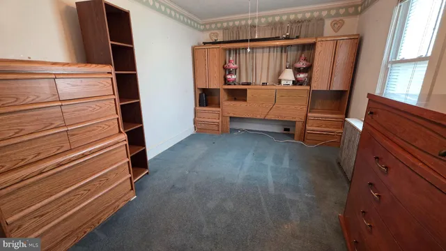 a view of room with window and wooden floor