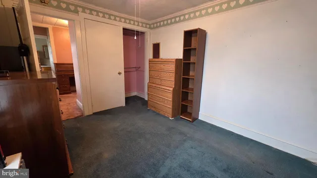 an empty room with closet and mirror