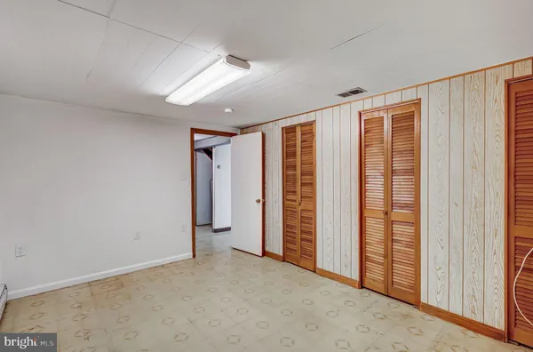 an empty room with closet area
