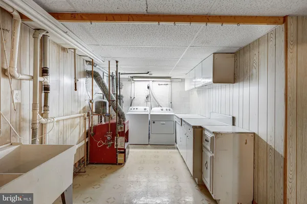 a kitchen with a refrigerator and white cabinets