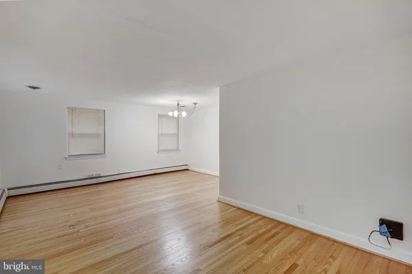 a view of an empty room and wooden floor