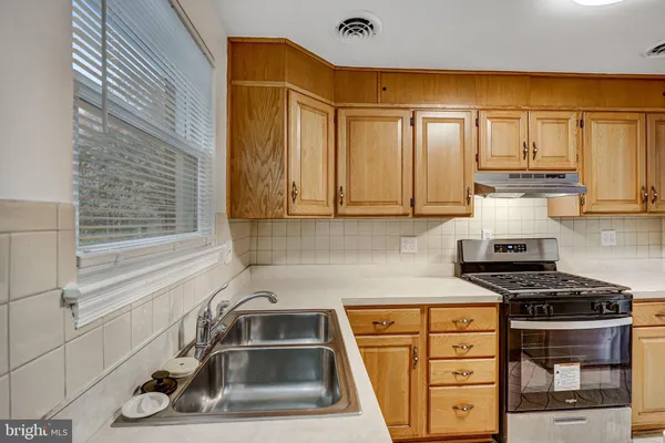 a kitchen that has a sink and a stove