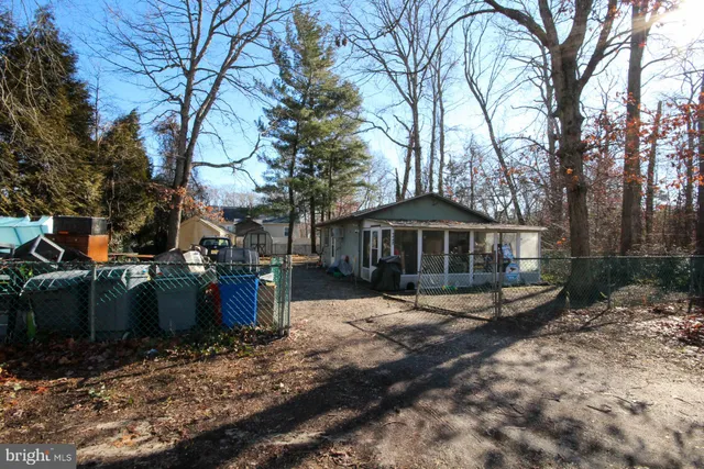 a view of a house with a yard covered in snow