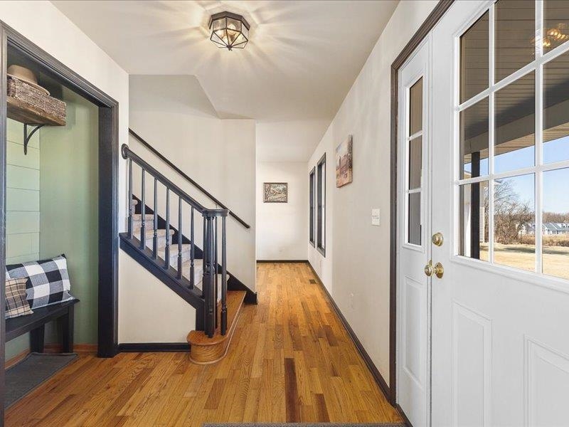 911.41 Melugins Grove Compton, IL 61318 - Photo 12 of 68 a view of a hallway with wooden floor and staircase