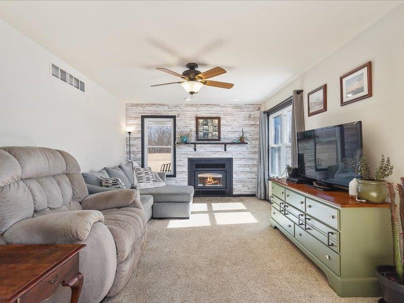 911.41 Melugins Grove Compton, IL 61318 - Photo 15 of 68 a living room with furniture a flat screen tv and a fireplace