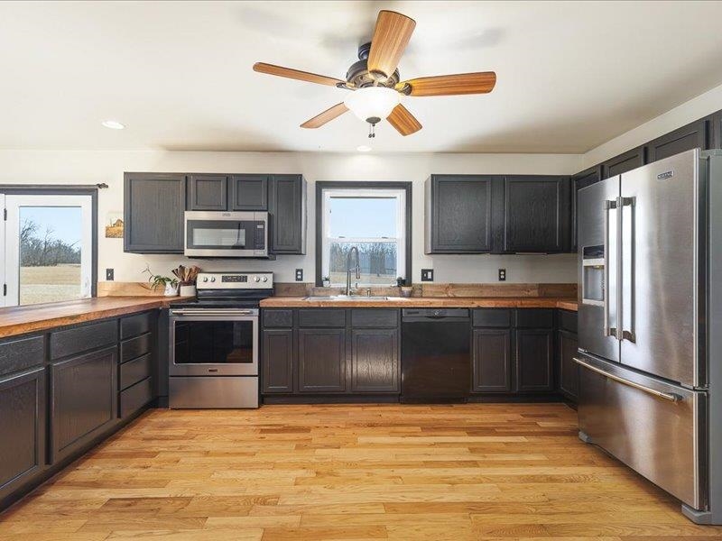 911.41 Melugins Grove Compton, IL 61318 - Photo 19 of 68 a kitchen with stainless steel appliances granite countertop a refrigerator a stove a sink dishwasher a oven with a dining table and chairs