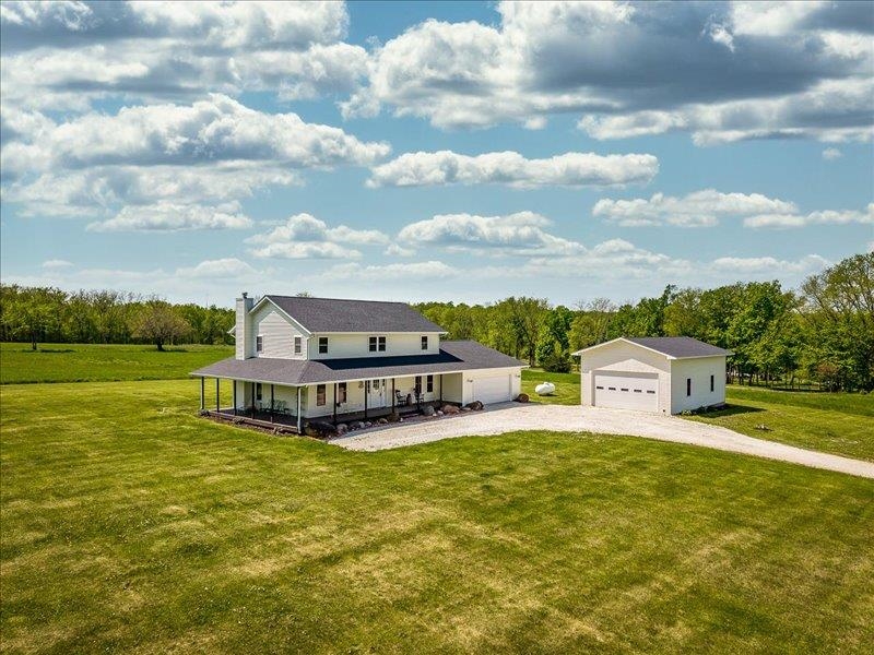 911.41 Melugins Grove Compton, IL 61318 - Photo 2 of 68 a view of a lake with house in front of it