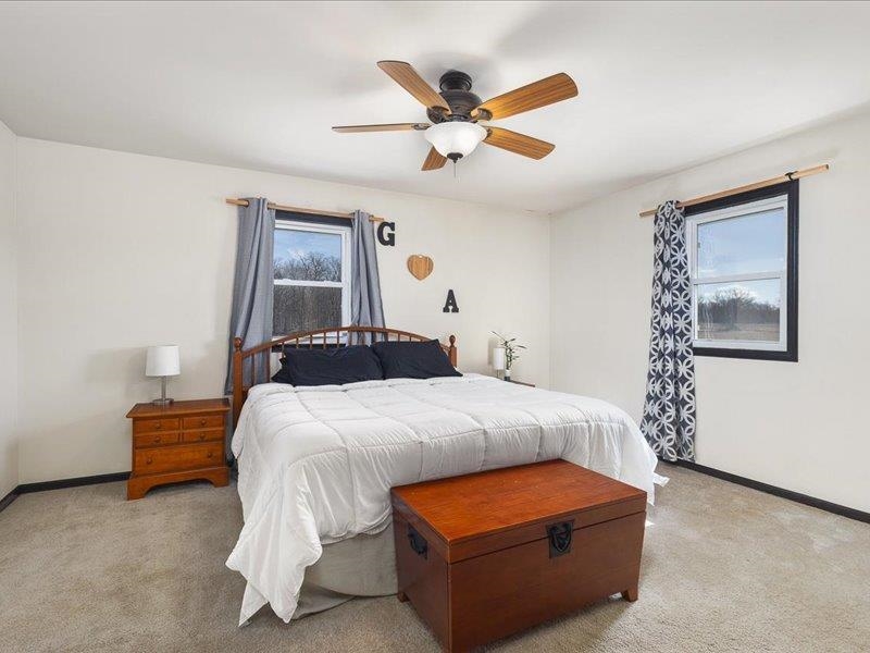 911.41 Melugins Grove Compton, IL 61318 - Photo 30 of 68 a bedroom with a bed and a chandelier