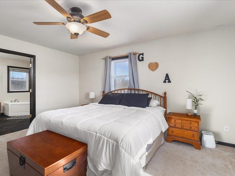 911.41 Melugins Grove Compton, IL 61318 - Photo 31 of 68 a bedroom with a bed and a chandelier