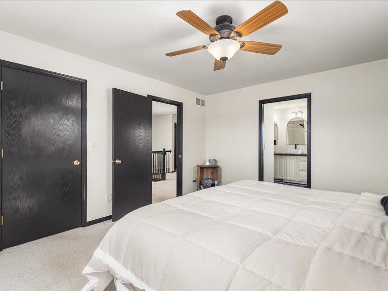 911.41 Melugins Grove Compton, IL 61318 - Photo 32 of 68 a bedroom with a large bed and a chandelier