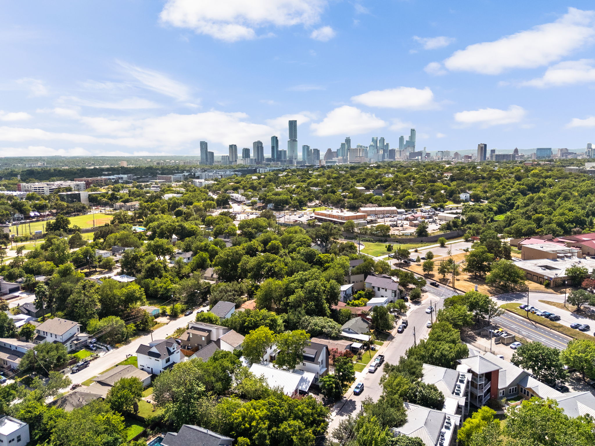 2717 Lyons Road, Unit 1 Austin, TX 78702 - Photo 33 of 40 An aerial perspective reveals a verdant neighborhood seamlessly blending with the urban skyline.