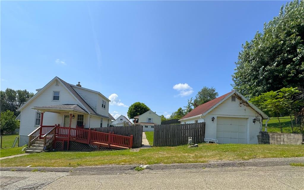 a view of a house with a yard and porch