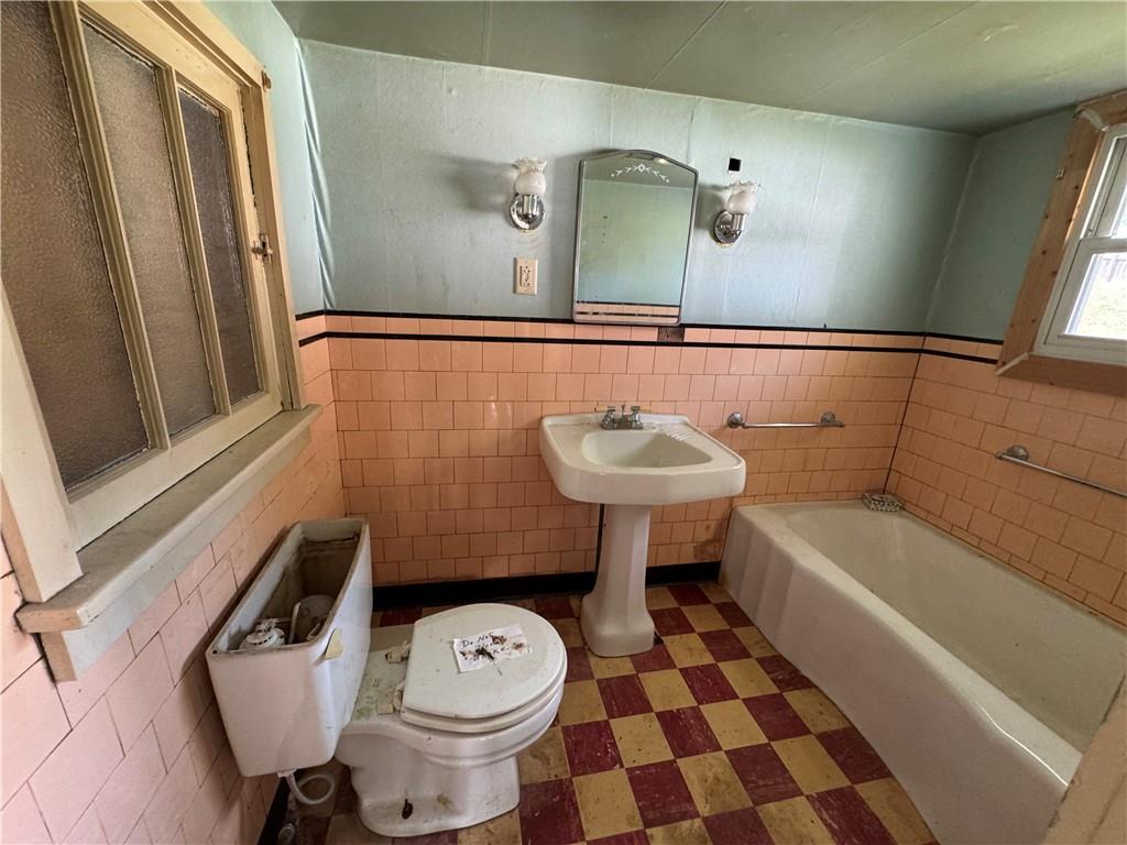 1076-1078 Addison Street Washington, PA 15301 - Photo 42 of 50 a bathroom with a sink a toilet and a mirror