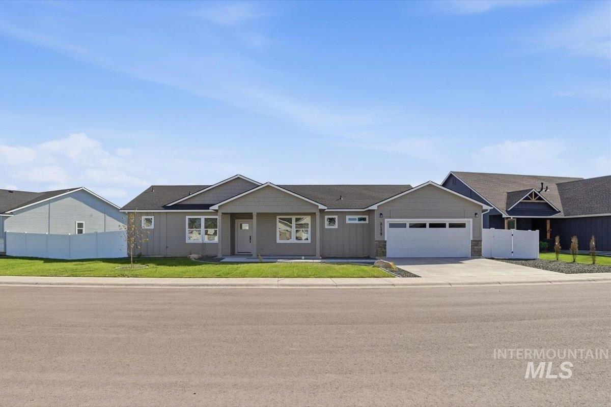 2175 Austin Way Fruitland, ID 83619 - Photo 2 of 30 View of front of house with driveway, a garage, and stone siding