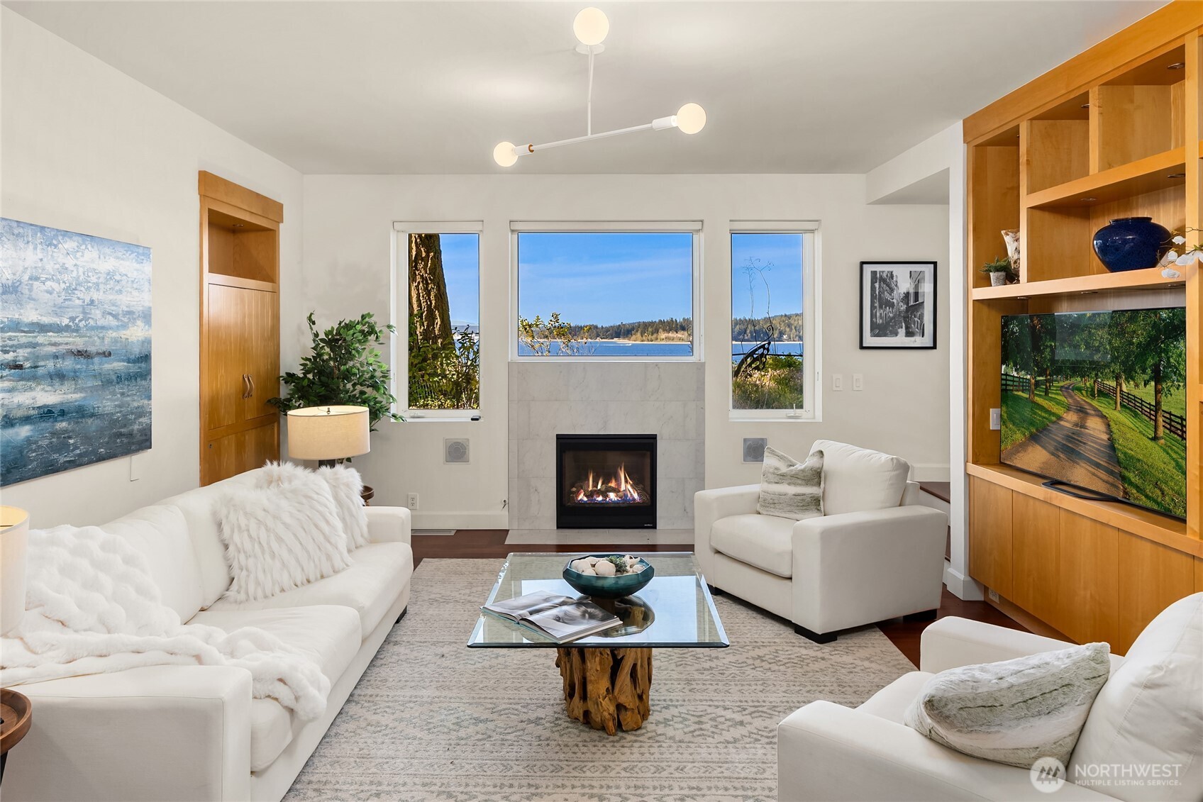 12145 Arrow Point Loop Northeast Bainbridge Island, WA 98110 - Photo 5 of 40 a living room with furniture and a fireplace