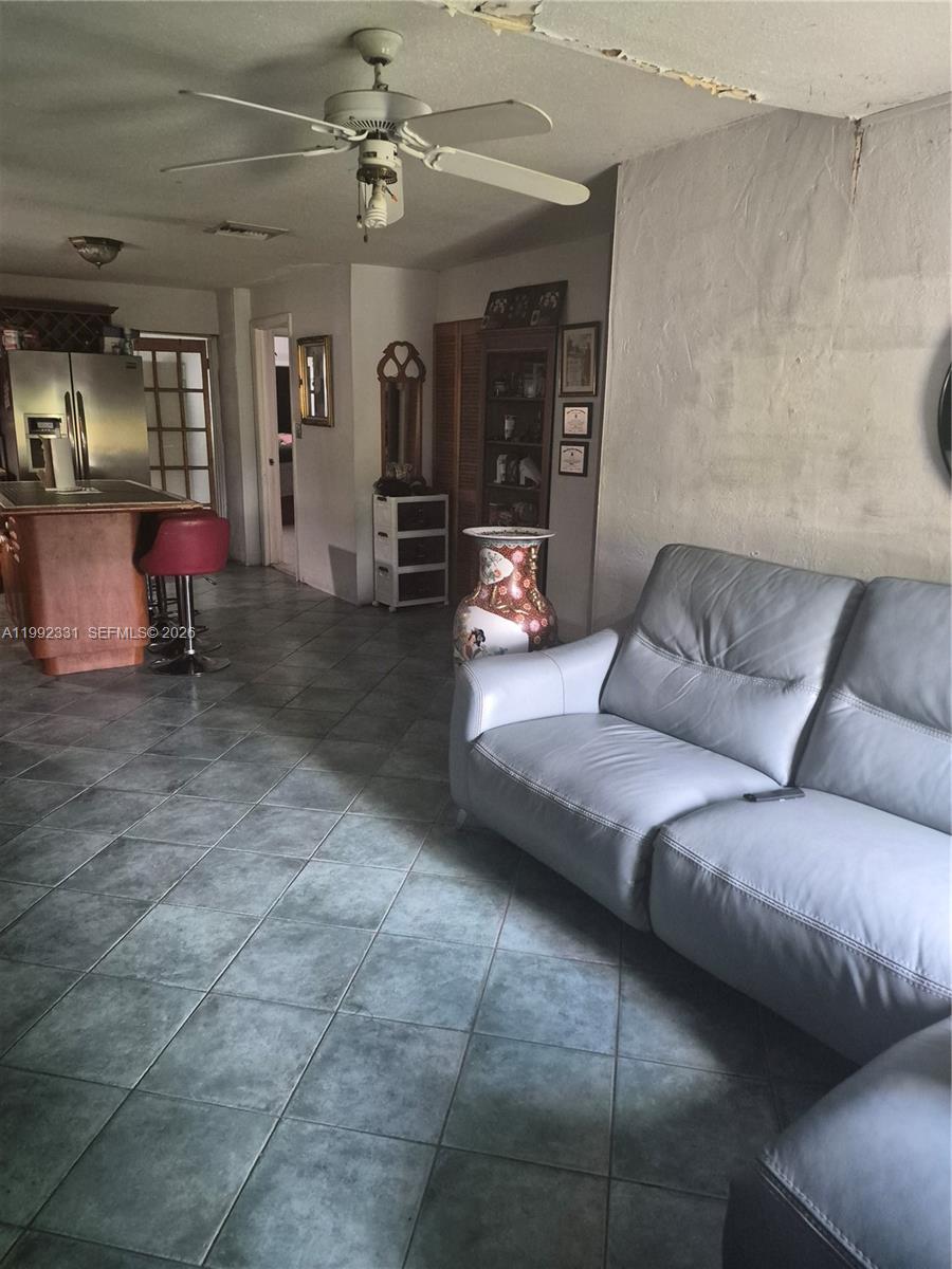 399 Northwest 98th Street Miami, FL 33150 - Photo 2 of 7 a living room with furniture and a chandelier