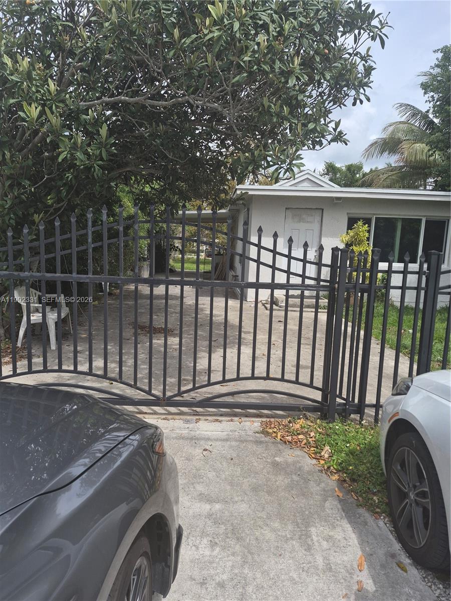 399 Northwest 98th Street Miami, FL 33150 - Photo 4 of 7 a front view of a house with a garden