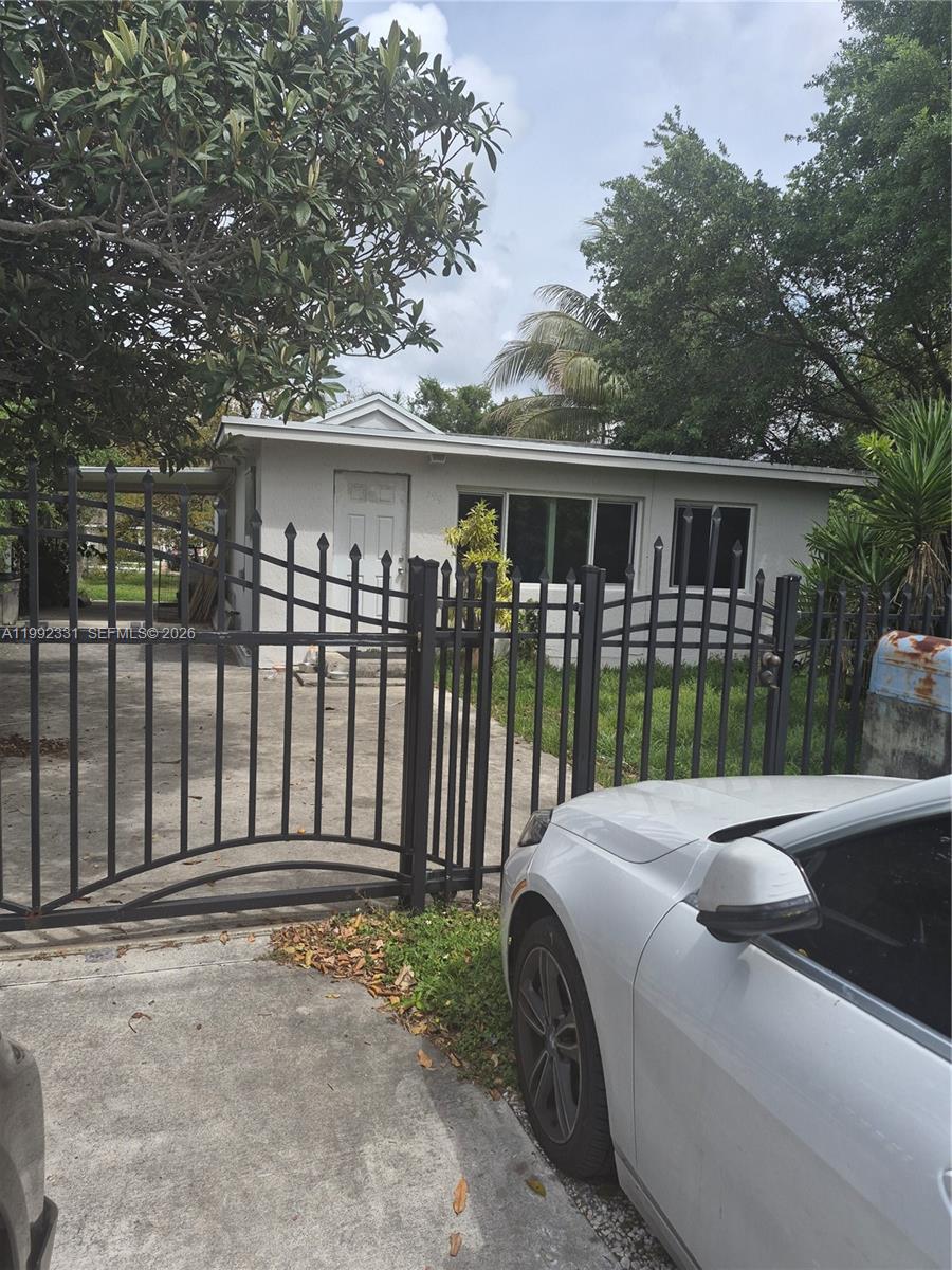 399 Northwest 98th Street Miami, FL 33150 - Photo 5 of 7 a front view of a house with a garden