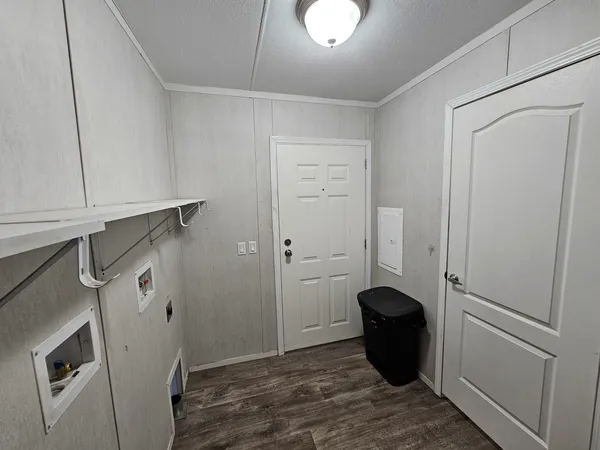 a view of storage and utility room with refrigerator