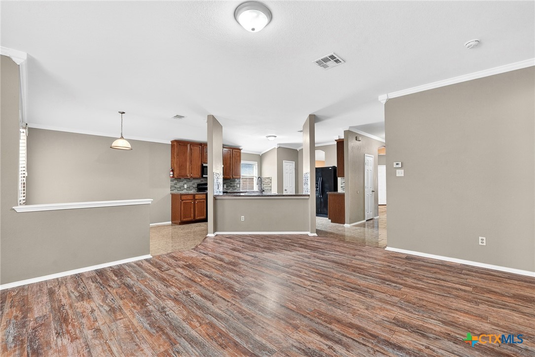 6300 Taree Loop Killeen, TX 76549 - Photo 4 of 13 a view of a kitchen with wooden floor and a kitchen
