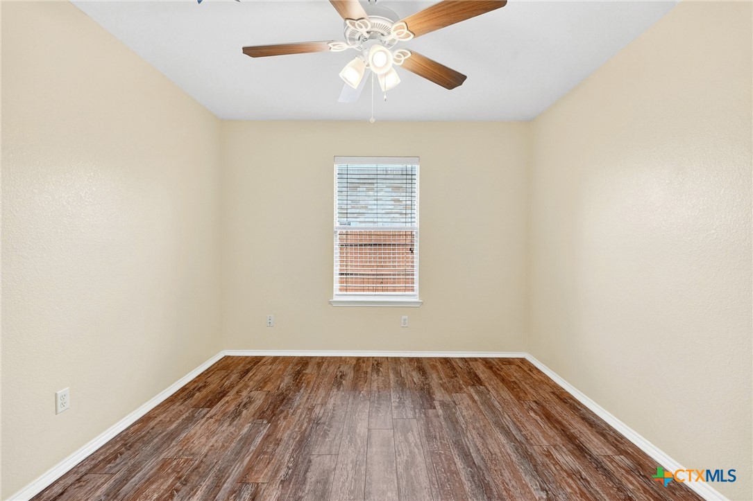 6300 Taree Loop Killeen, TX 76549 - Photo 10 of 13 a view of an empty room with wooden floor and a window