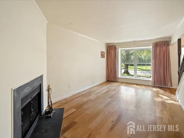 wooden floor in an empty room with a fireplace