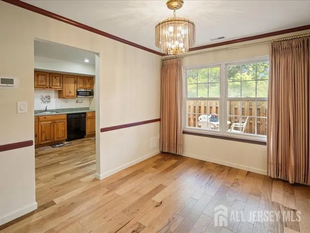 a view of a kitchen with wooden floor and a sink