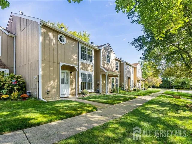 a view of a big building with a big yard and plants