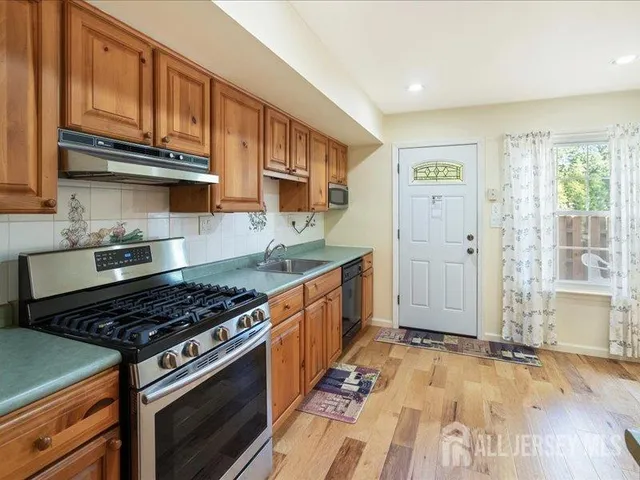 a kitchen with stainless steel appliances granite countertop a stove and a sink