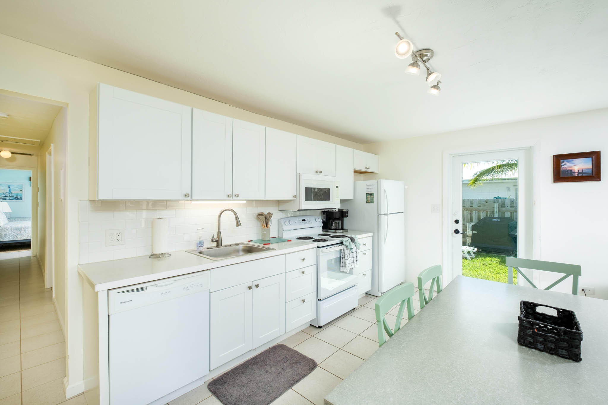 261 9th Street Key Colony Beach, FL 33051 - Photo 11 of 42 a kitchen with a sink stove and cabinets