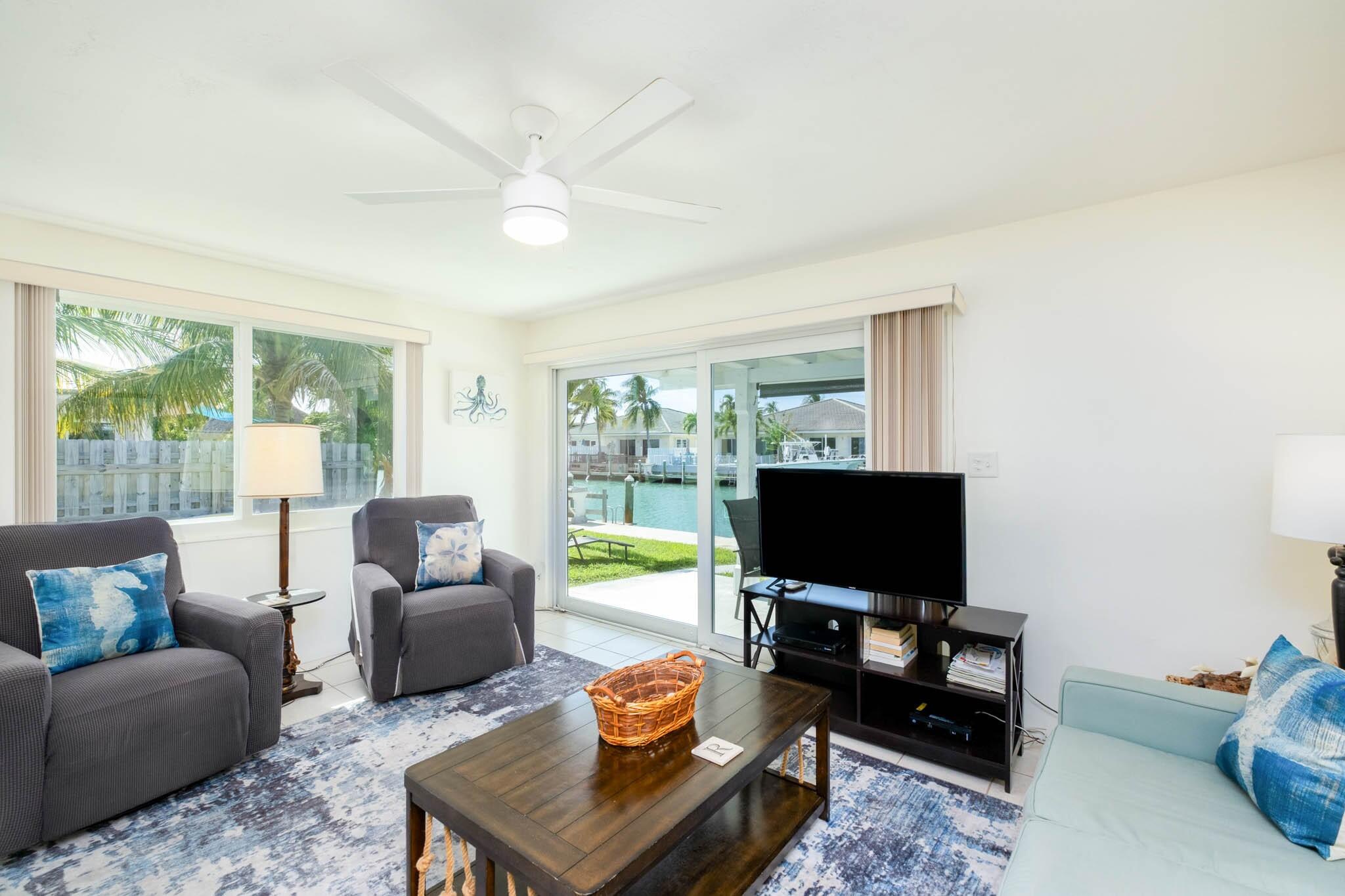 261 9th Street Key Colony Beach, FL 33051 - Photo 12 of 42 a living room with furniture and a flat screen tv