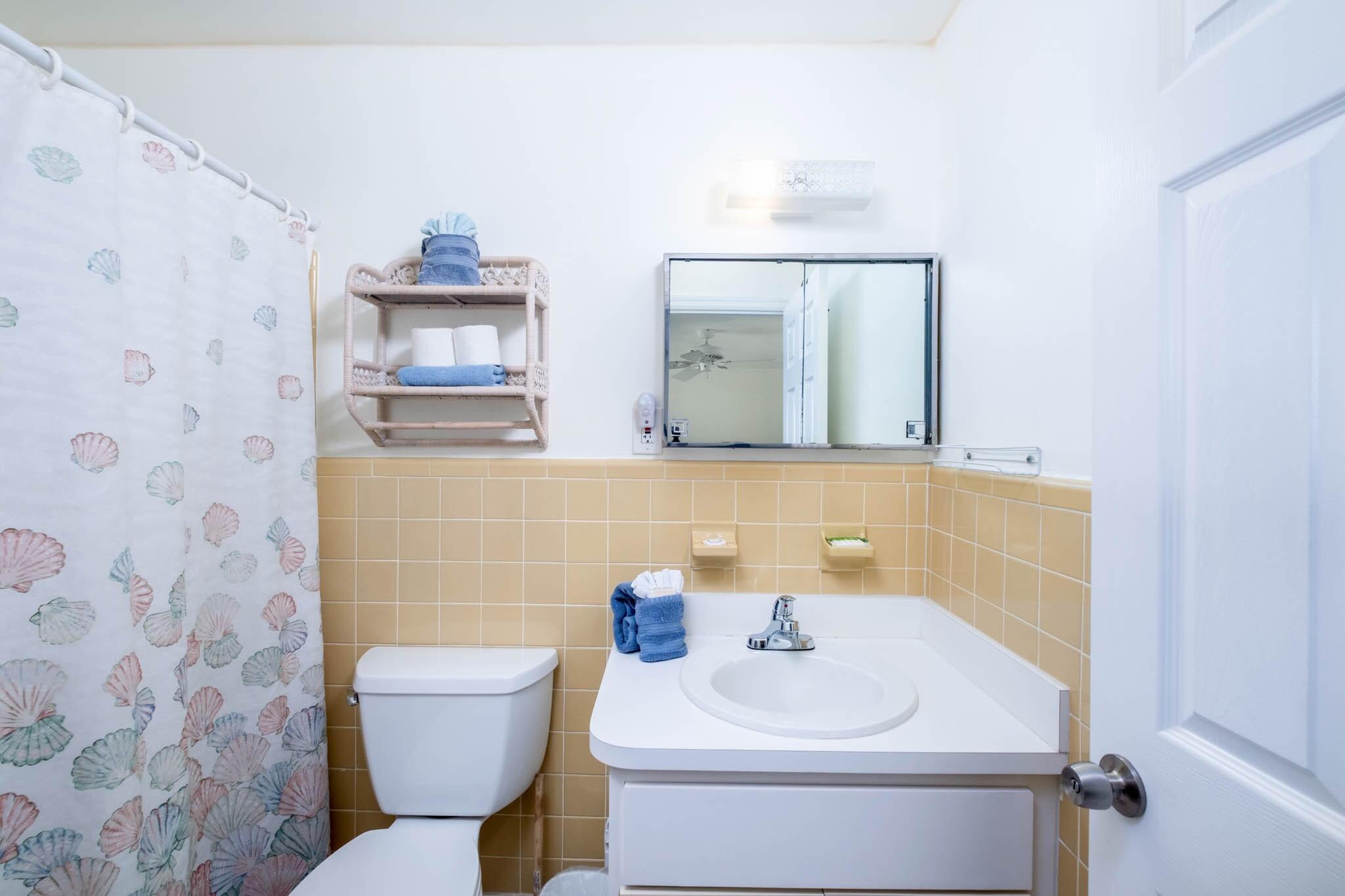 261 9th Street Key Colony Beach, FL 33051 - Photo 17 of 42 a bathroom with a toilet sink and mirror