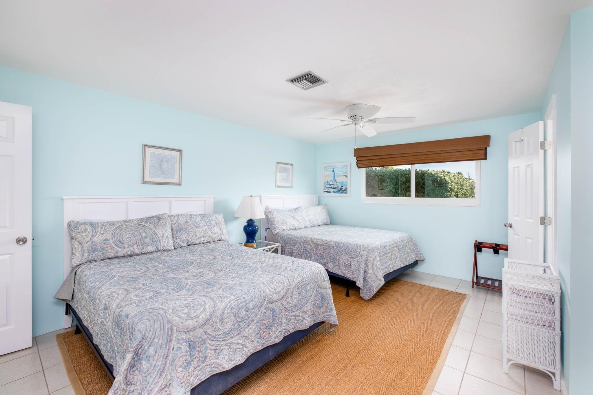 261 9th Street Key Colony Beach, FL 33051 - Photo 19 of 42 a bedroom with two beds and wooden floor