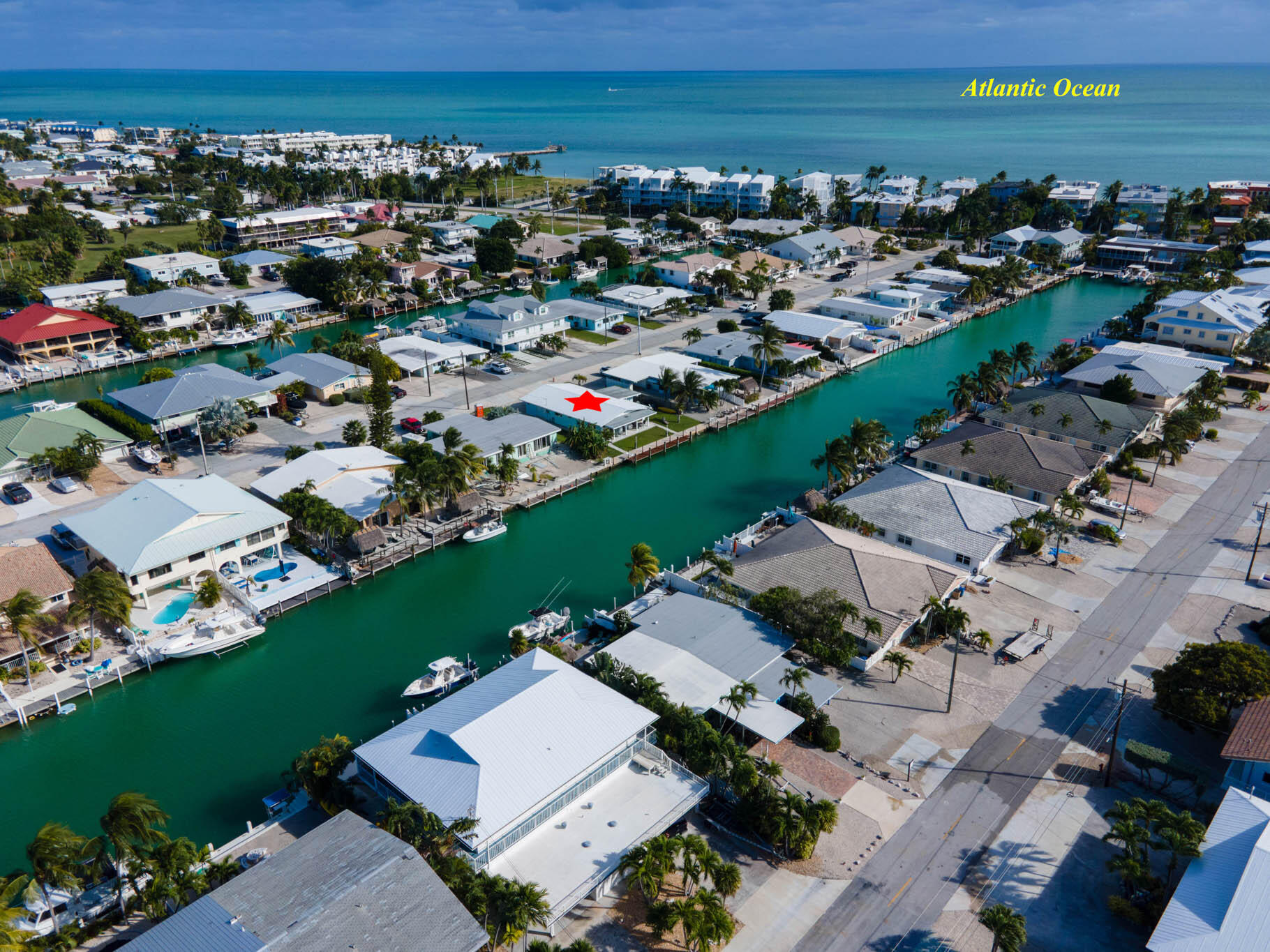261 9th Street Key Colony Beach, FL 33051 - Photo 35 of 42 an aerial view of a city with lots of residential buildings and ocean view in back
