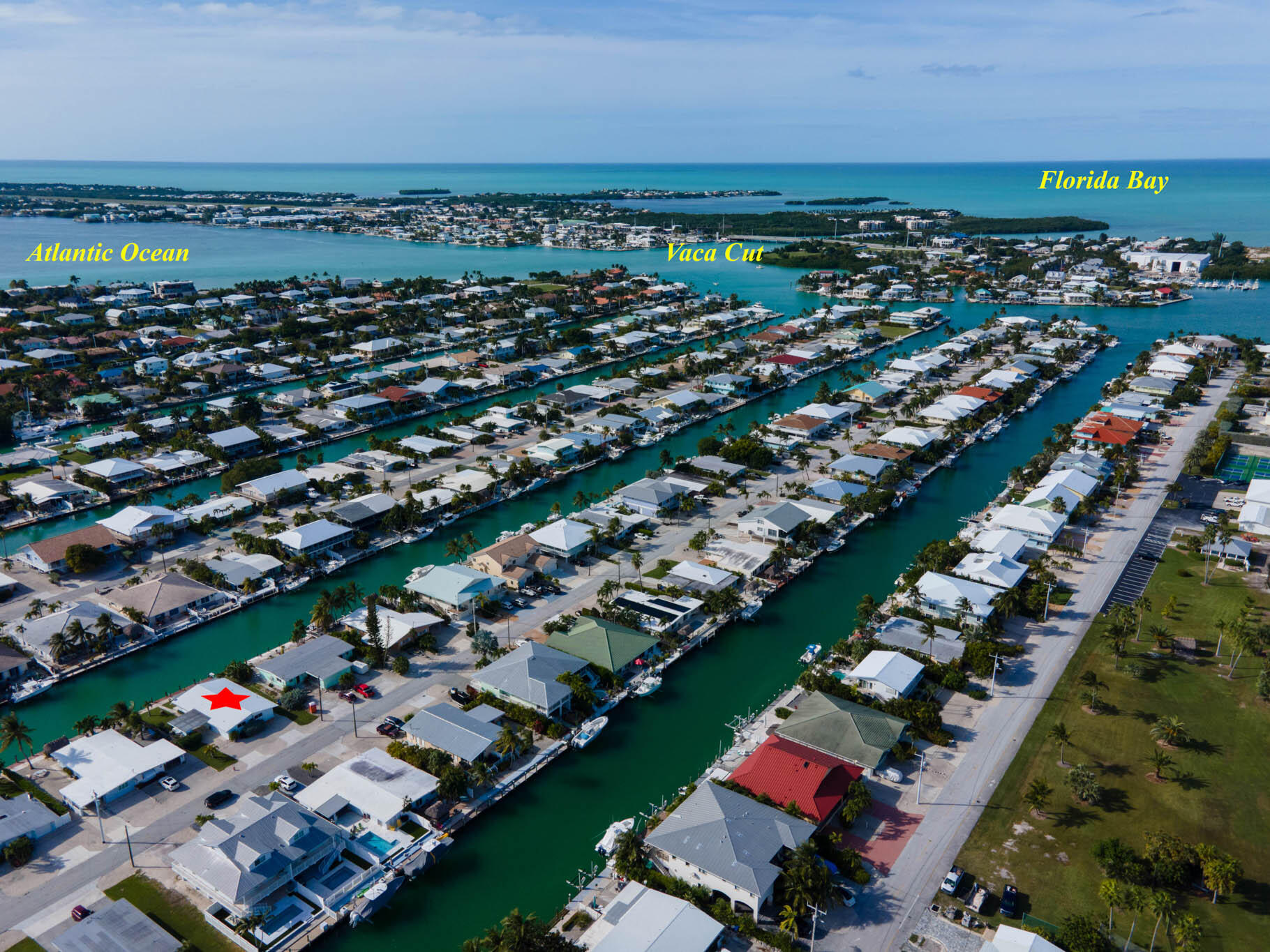261 9th Street Key Colony Beach, FL 33051 - Photo 36 of 42 an aerial view of a city with lots of residential buildings and ocean view in back