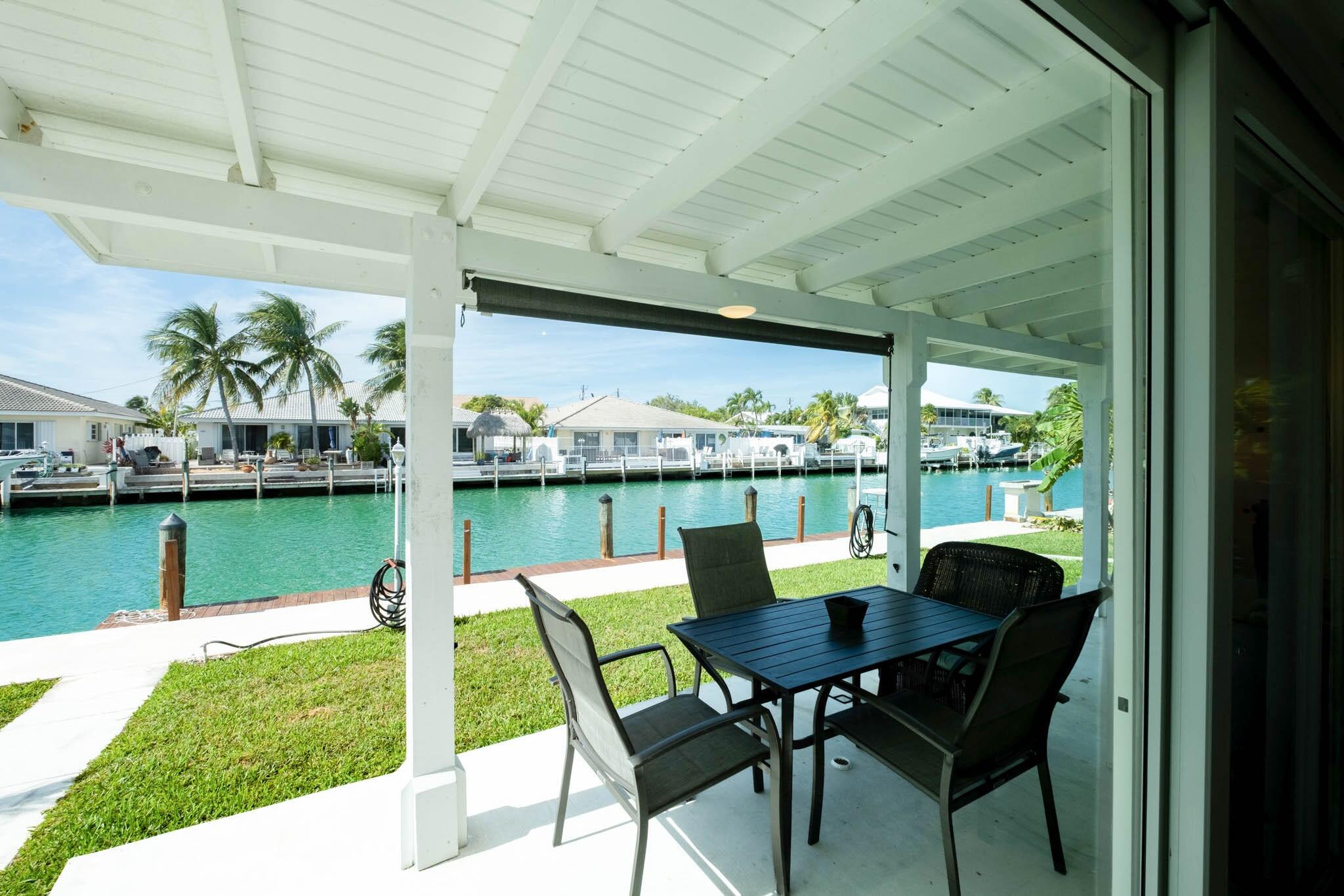 261 9th Street Key Colony Beach, FL 33051 - Photo 6 of 42 a view of a porch with furniture and a yard
