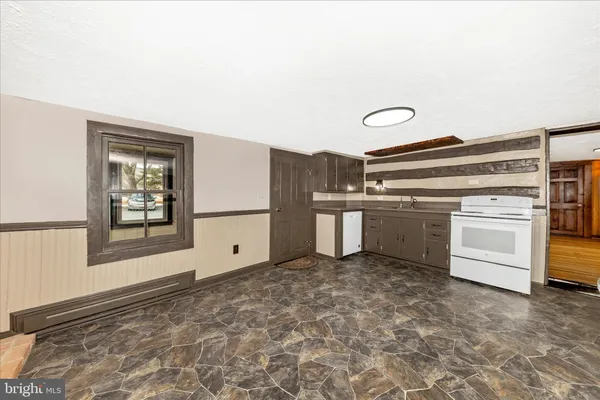 a kitchen with refrigerator and cabinets