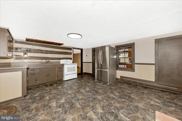 a kitchen with white cabinets and white appliances