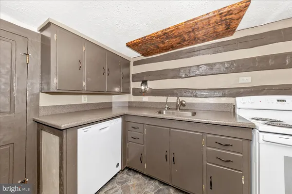a view of empty room with wooden floor and cabinet