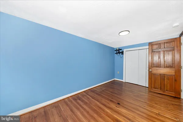 a view of a room with wooden floor and wall painting