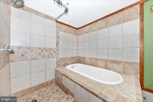 a view of balcony with wooden floor and a shower