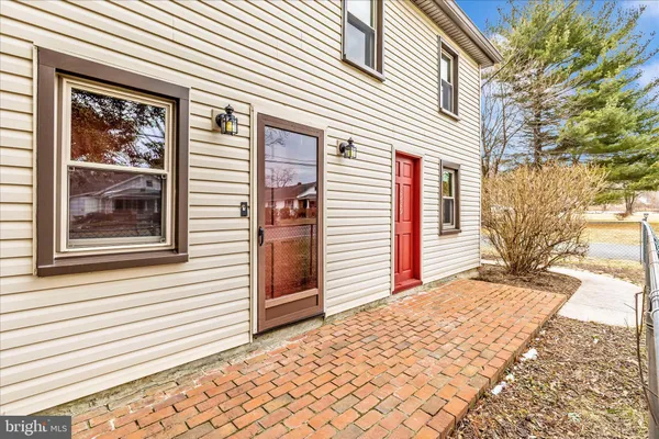 a view of a house with pool and sitting area